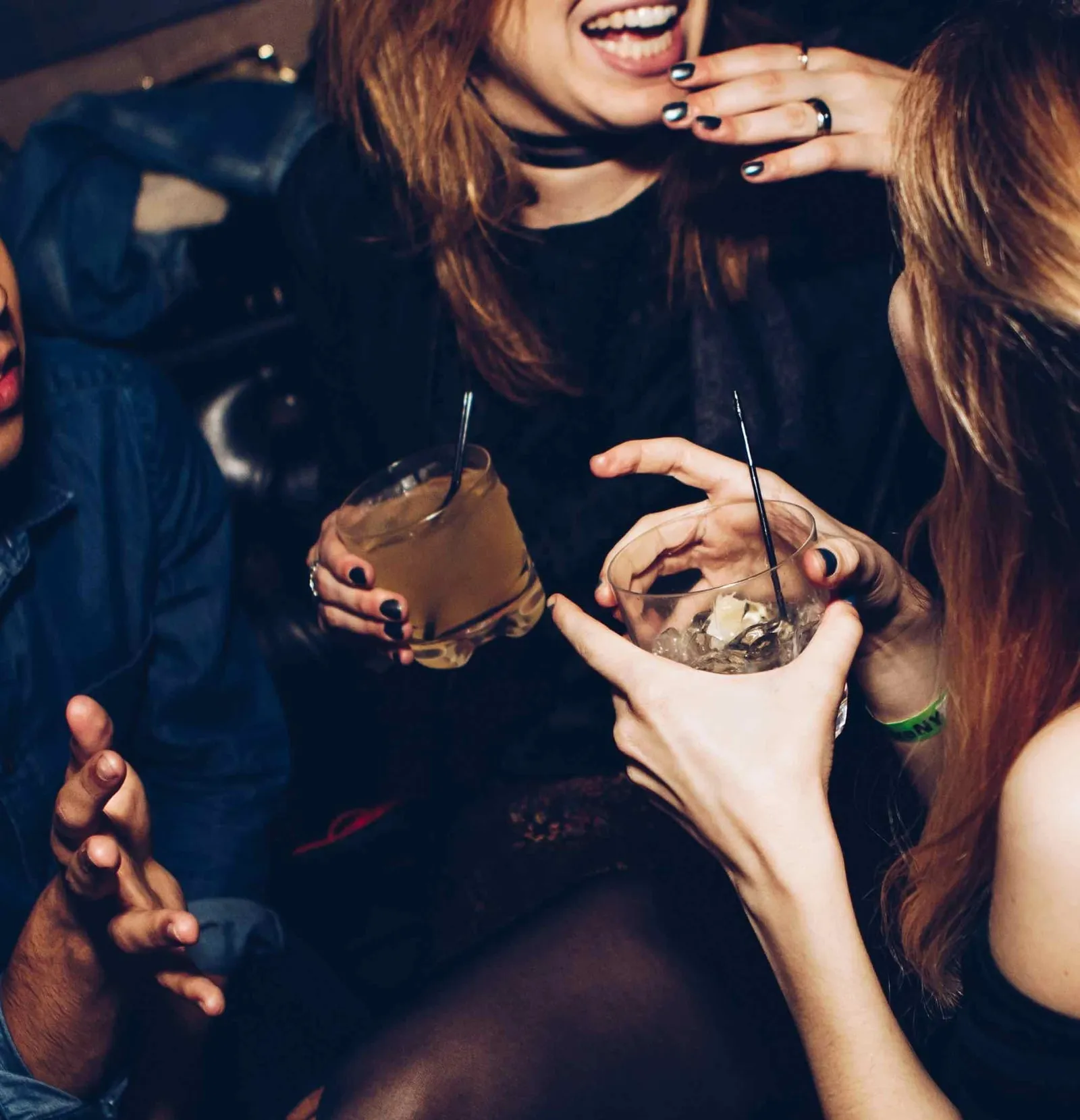 Group of friends drinking at a bar, a common cause of dehydration.