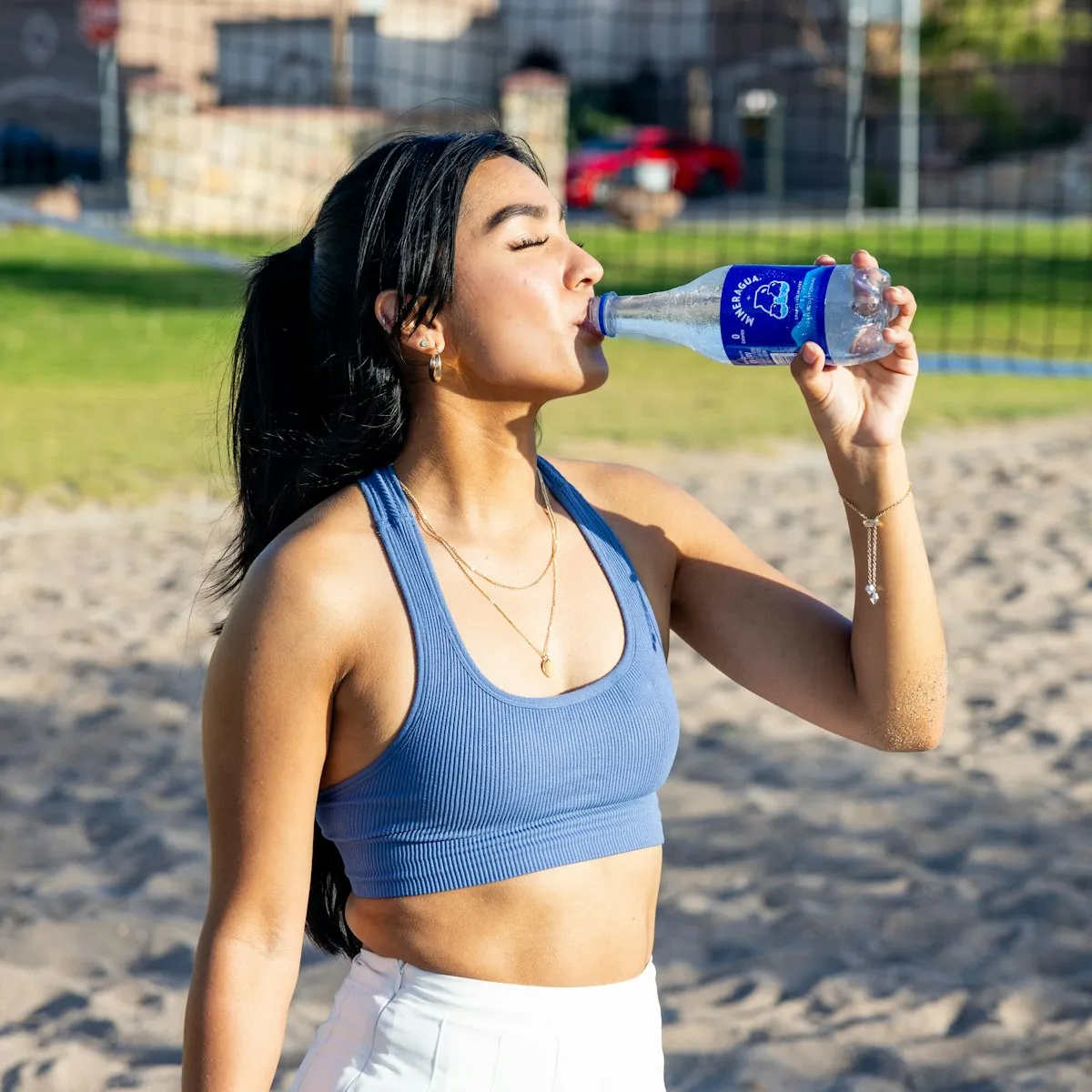Woman staying hydrated while enjoying the Los Angeles coastline