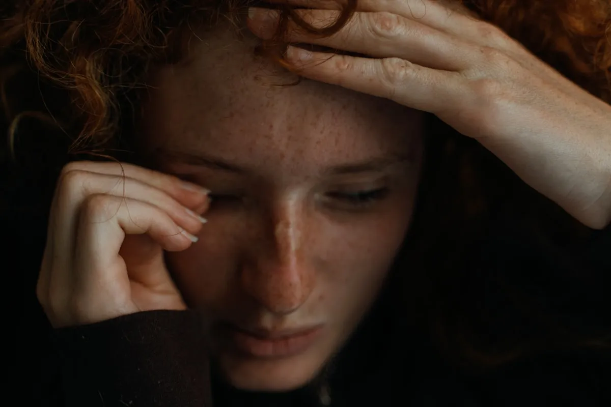 Person holding their head during hangover recovery in Los Angeles