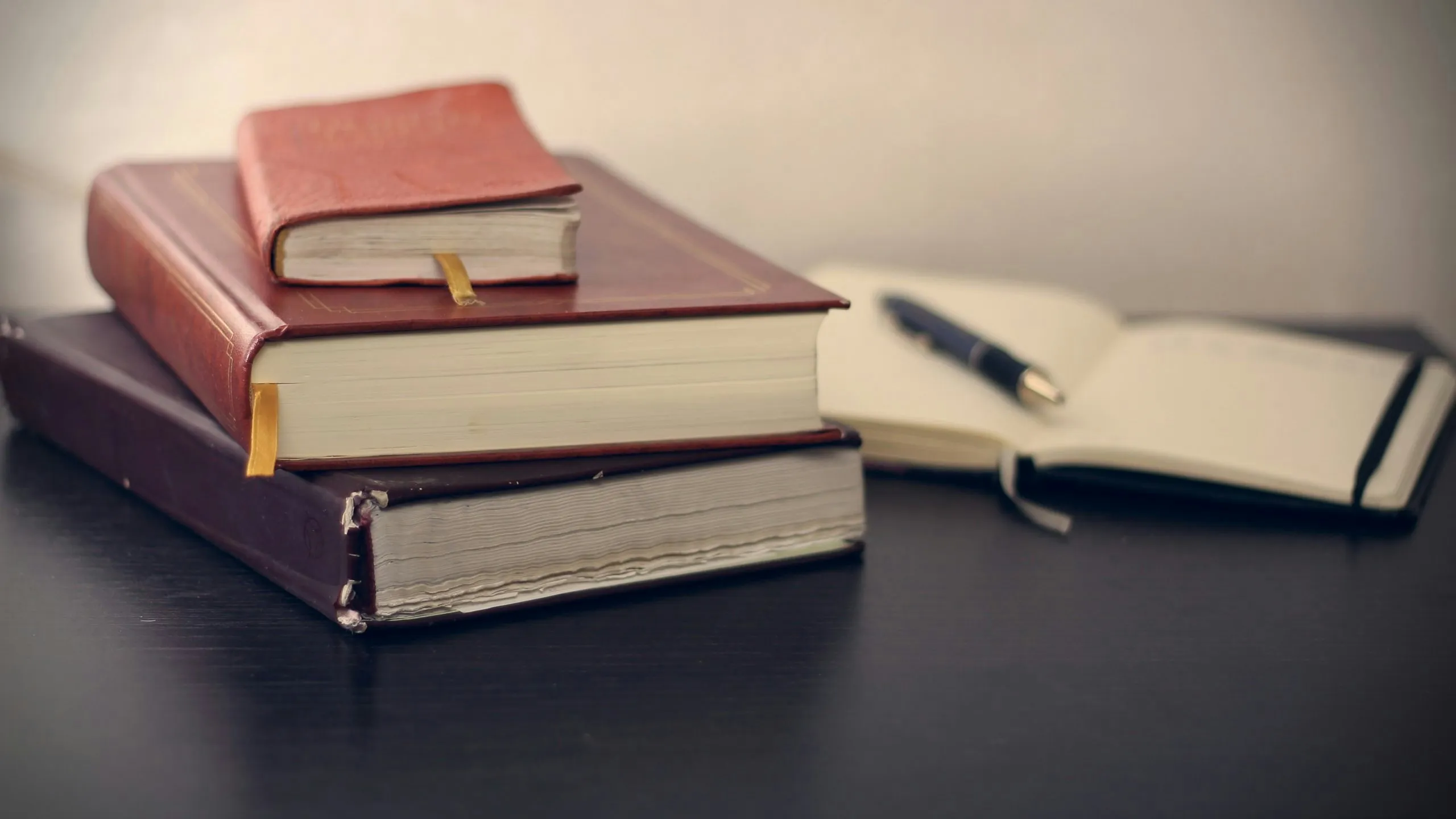 Stack of legal books and notebook symbolizing California IV therapy laws and mobile medical regulations