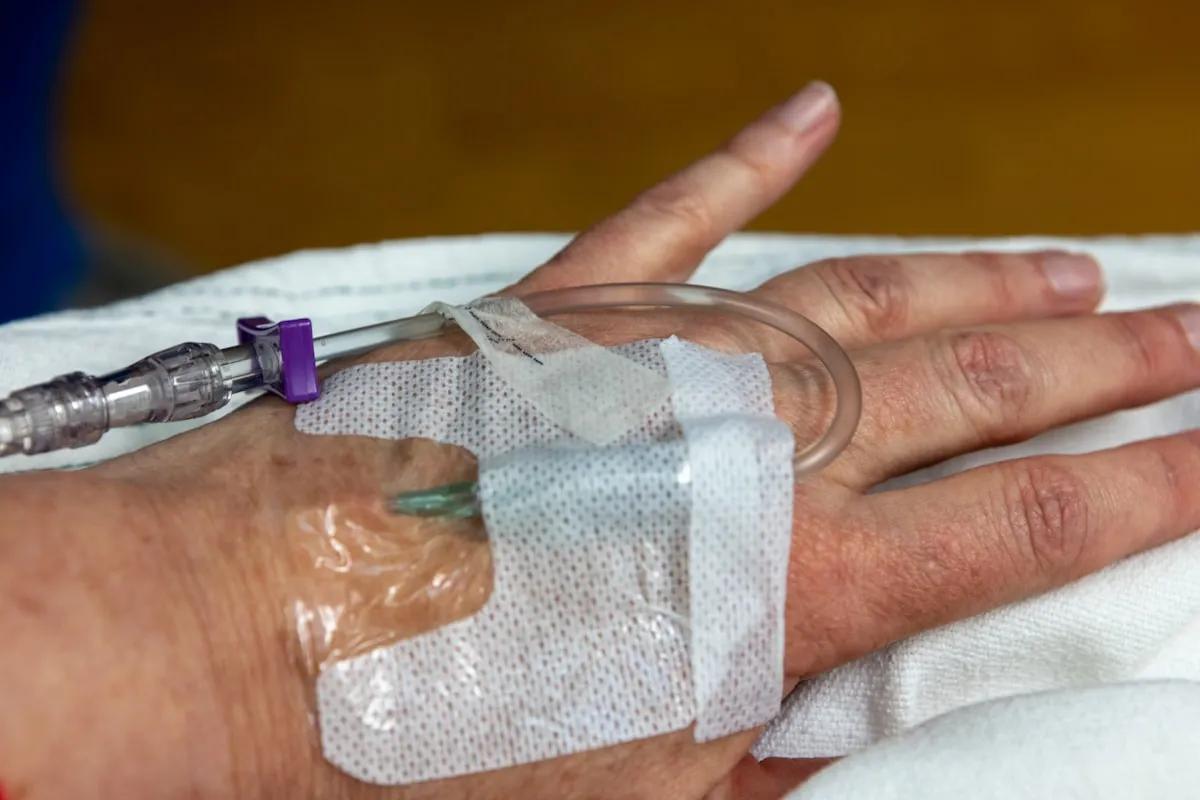 IV drip therapy session showing catheter placement by a licensed nurse