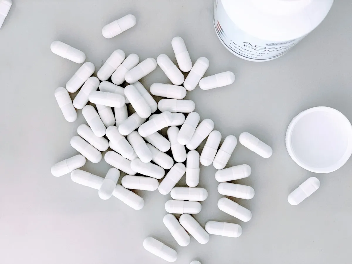 White supplement capsules representing oral NAD+ supplements compared to IV therapy in Los Angeles