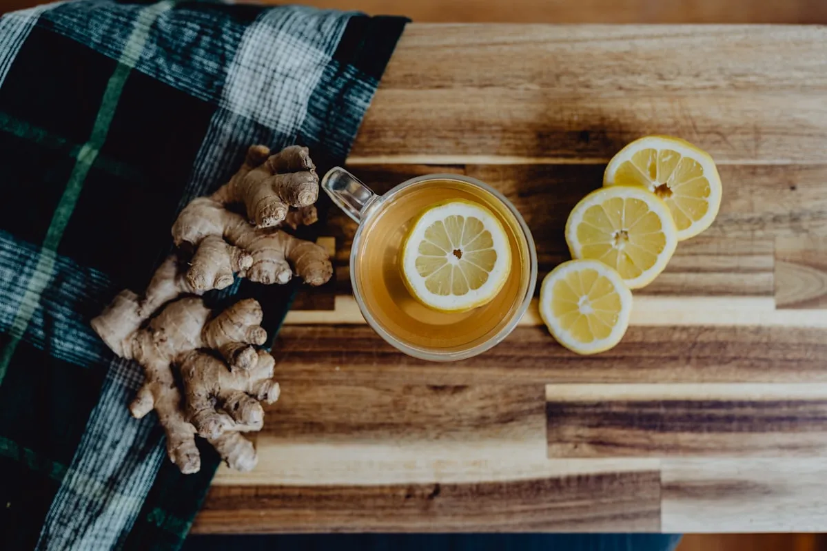 Ginger tea with lemon, a natural nausea remedy, on a wooden table in Los Angeles